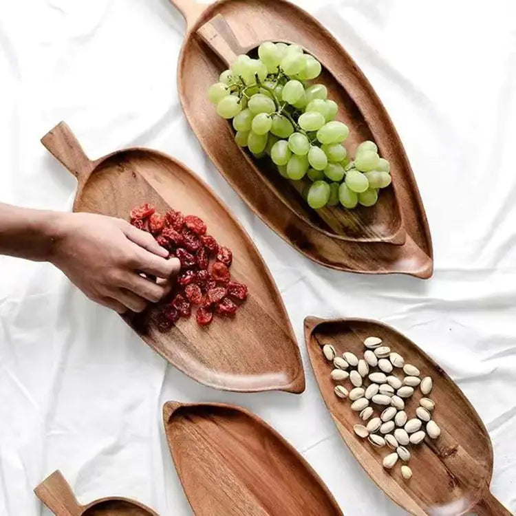 Wooden serving trays with food on a white surface