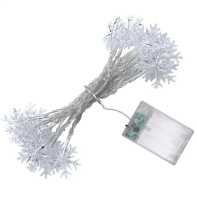 String lights with snowflake decorations and a battery pack on a white background