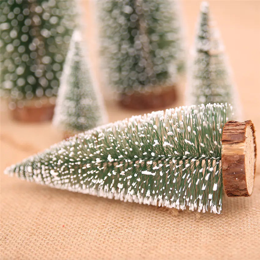 Decorative Christmas tree made of greenery with a wooden base on a beige surface.