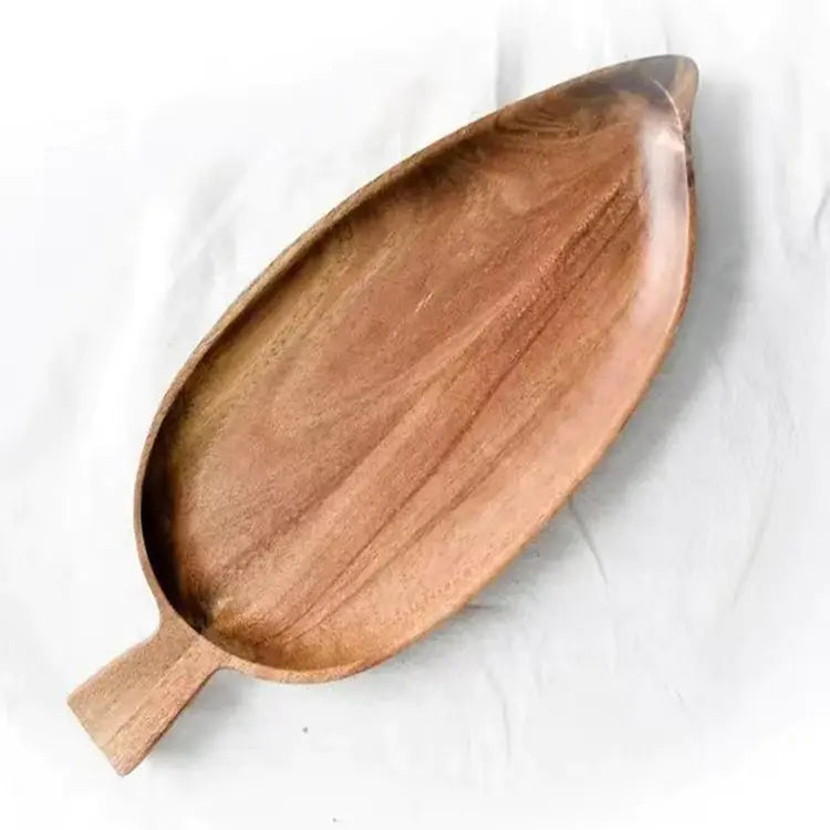 Wooden leaf-shaped tray on a white background