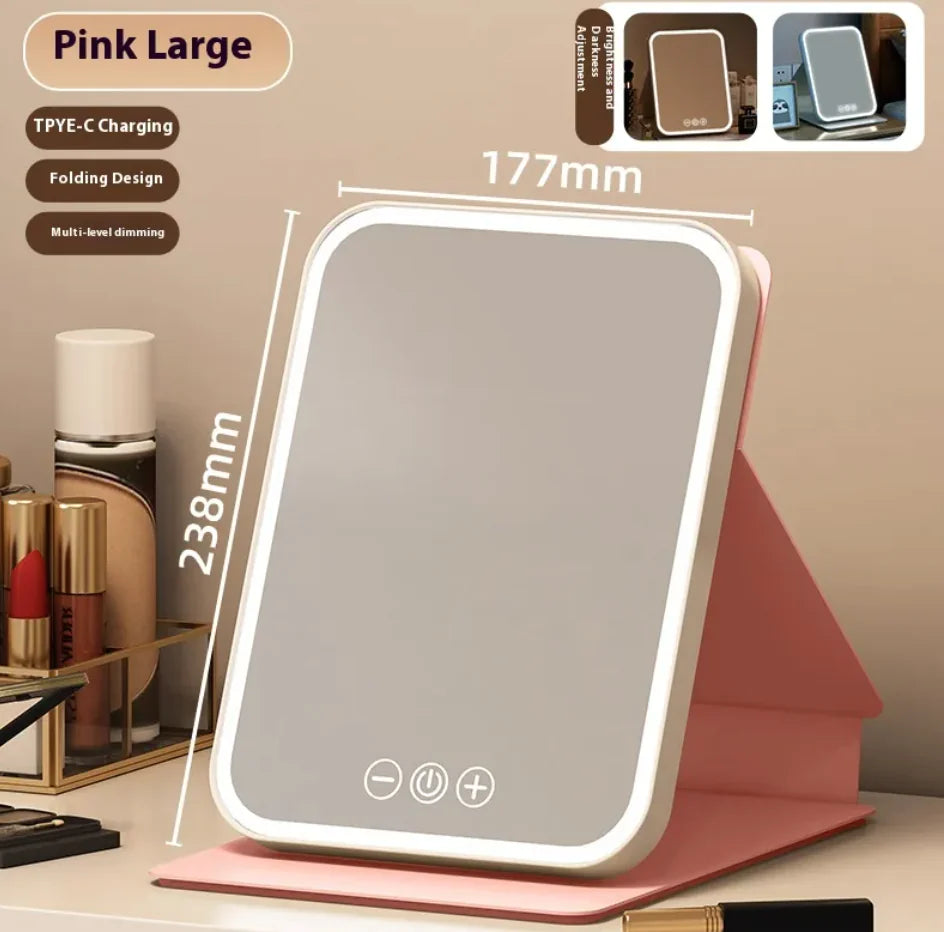 Pink large LED mirror with charging and folding design features on a beige background