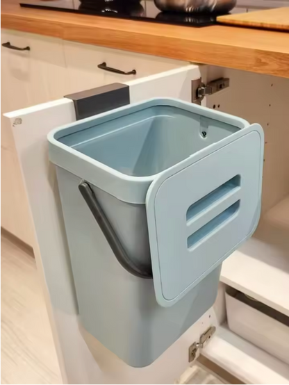 Blue trash bin mounted inside a kitchen cabinet
