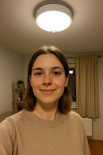 Woman smiling in a room with a light fixture on the ceiling