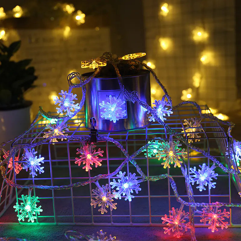 String lights with snowflake designs on a decorative stand with a blurred background