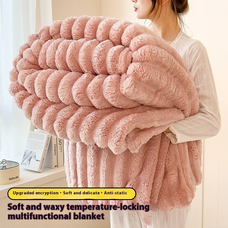 Person holding a large pink fluffy blanket with text describing its features.